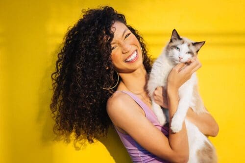 smiling woman holding a cat